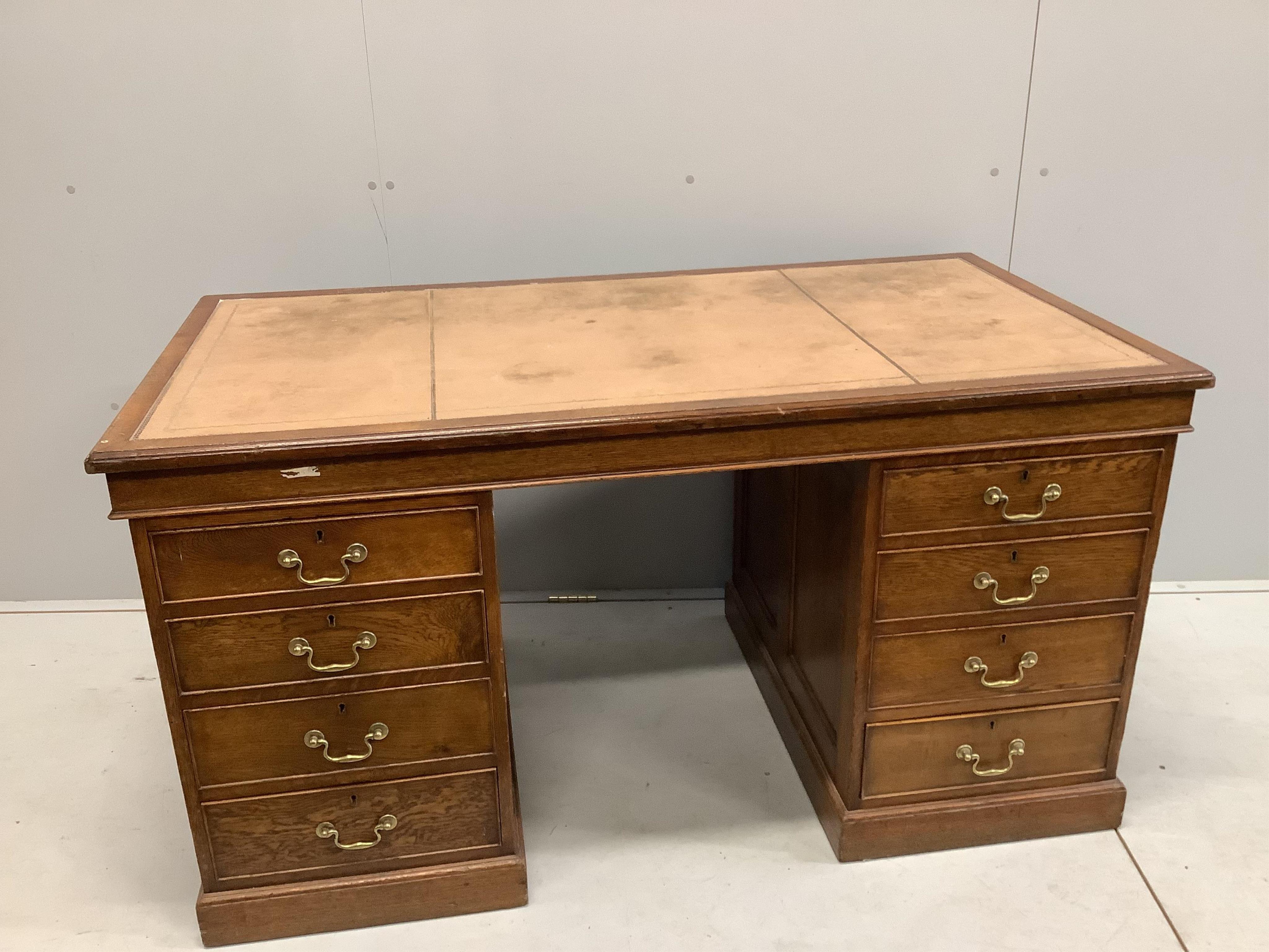 An early 20th century oak pedestal desk, bears George V cypher and stamped John Walsh Ltd Sheffield, width 142cm, depth 75cm, height 75cm. Condition - fair